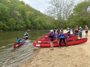 Students practicing their teamwork skills on the river